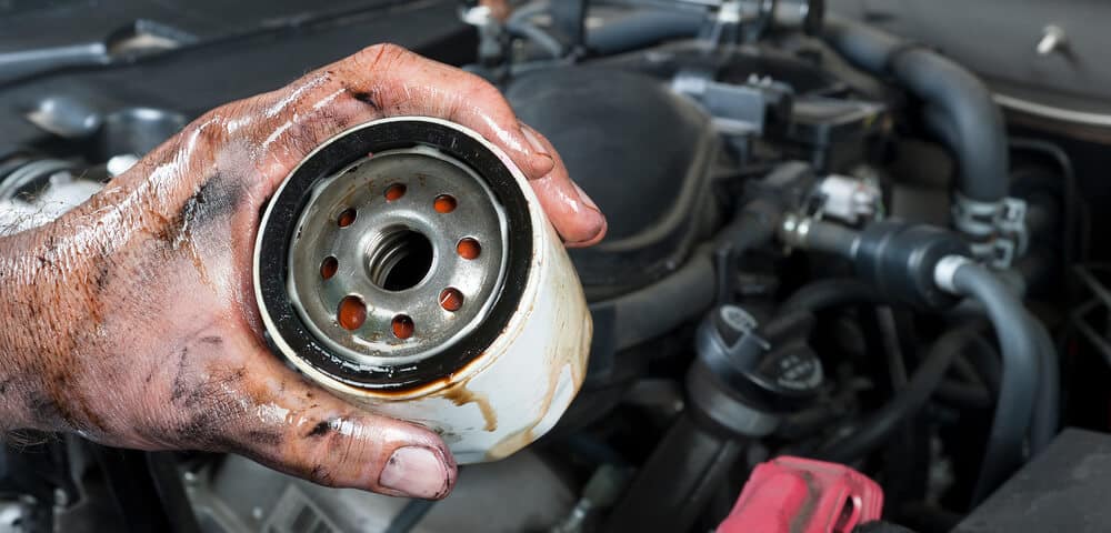 Auto-mechanic-holding-oil-filter