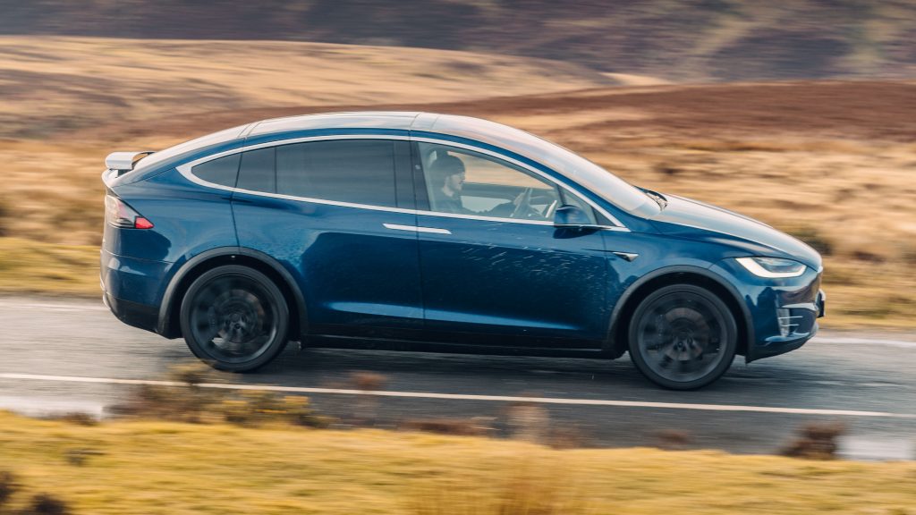 Tesla Model X is parked on the side of the road