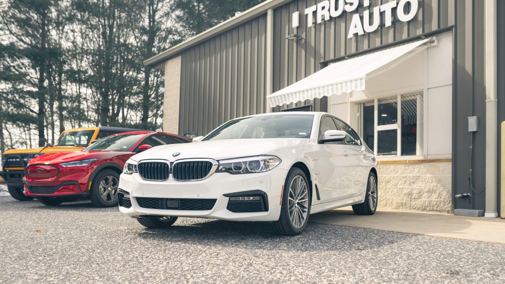 White BMW parked in the front of Trust Auto