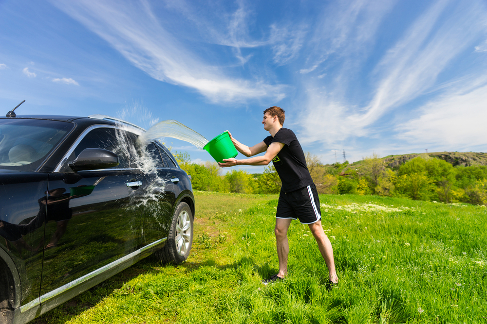 Person Spring Cleaning a car in the field