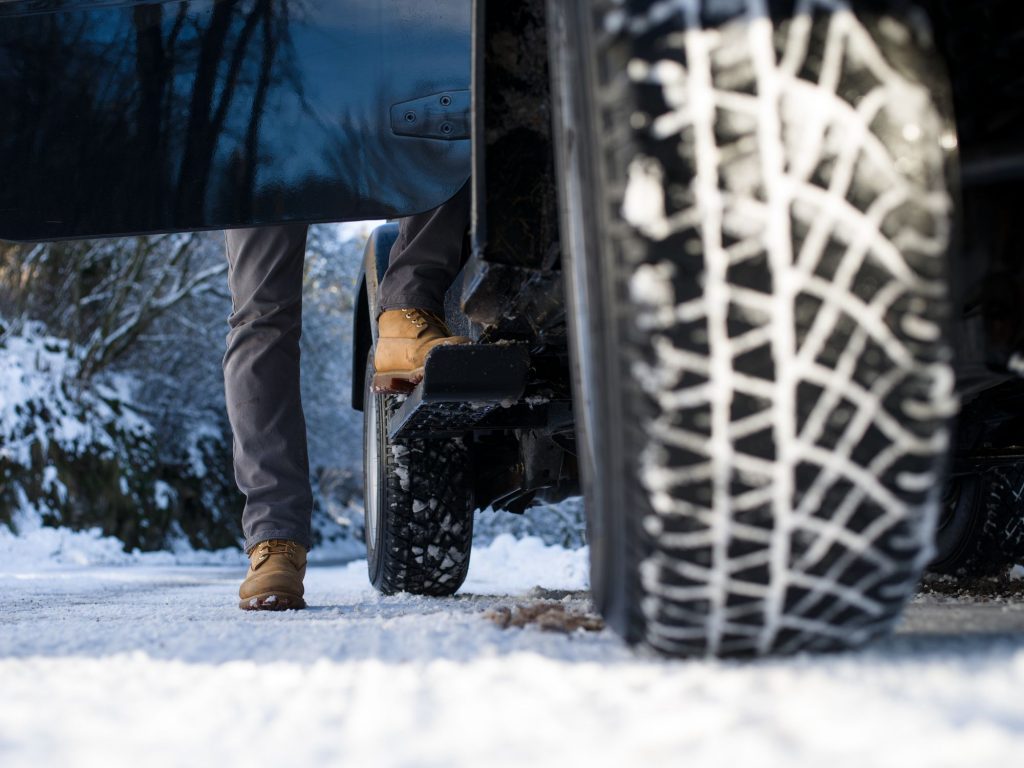 view-of-a-jeep-tire-on-a-snow-covered-road